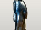 a silver statue of a man with a hat and a cane