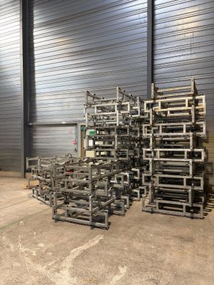 a large pile of metal crates in a warehouse