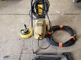 an image of a power washer and hoses in a garage