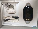 a camera in a box with a rope and a bag