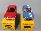two toy cars sitting next to each other on a table