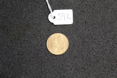a small coin that is on the ground next to a price tag