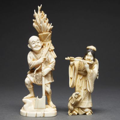 two carved ivory figurines of a man and a woman