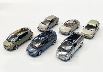 plusieurs petites voitures sont alignées sur une surface blanche