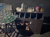a table with a lot of empty water bottles on it