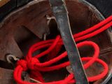 a close up of a helmet with a red rope tied to it