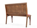 a wooden bench with a red cushion on top of it