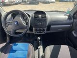 a dashboard of a car with a steering wheel and a blue seat