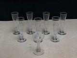 six empty wine glasses sitting on top of a table next to each other