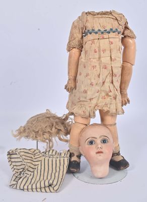 a doll and a doll head on a table