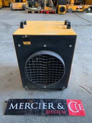 a close up of a yellow and black heater sitting on the ground