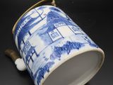 blue and white coffee cup with a handle on a black surface