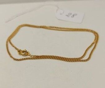 un collier en or auquel est attachée une chaîne