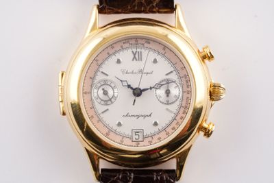 une montre-bracelet en or avec un cadran blanc et un bracelet en cuir marron