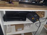 a printer sitting on a shelf next to a computer