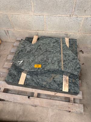 a pile of granite sitting on a pallet in a room