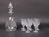 quatre verres à vin et une carafe posés sur une table