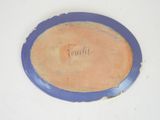 a blue plate with a writing on it on a white surface