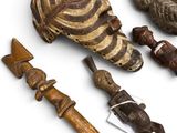 several pieces of african art are displayed on a white surface