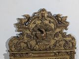 a gold frame with a picture of a bird on it