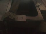 a sink in the middle of a room with a window