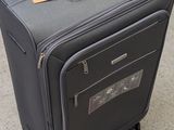 a piece of luggage sitting on the ground with a tag on it