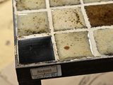 a close up of a tiled table with a label on it