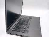a laptop that is open on a white surface