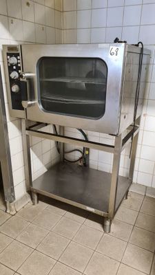 a silver microwave sitting on a stand in a kitchen