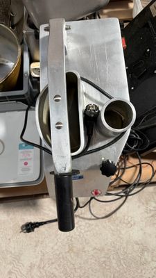 a machine that is sitting on the floor next to a bowl