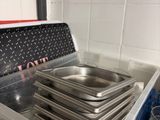 a stack of pans sitting on top of a plastic container