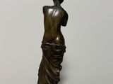 bronze statue of a woman holding a vase in her hand