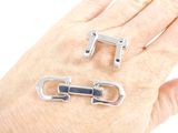 a hand that has a ring on it and a buckle on it