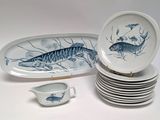 many plates and bowls that have fish on them