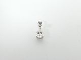 a close up of a single diamond pendant on a white surface