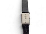a watch that is sitting on top of a white surface