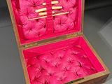a wooden box with pink fabric inside of it