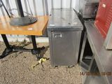 an image of a kitchen with a table and a refrigerator