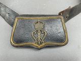 a belt with a crown on it on a table
