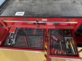 a red tool box with tools inside of it
