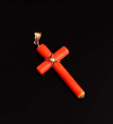 an orange cross on a black background with a gold chain around it