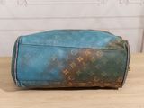 a blue and brown bag sitting on a wooden table