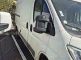 a white van parked in a parking lot next to a building
