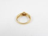a close up of a gold ring on a white surface