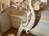 a white bench in a room with a mirror on the wall
