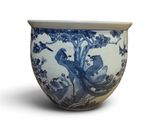 a blue and white bowl with a bird design on it