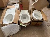 three toilets sitting in a cardboard box on the ground