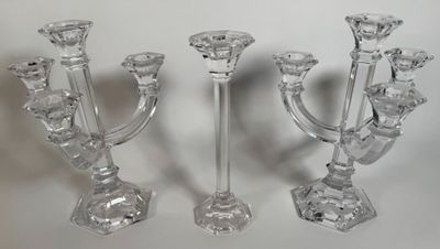 three glass candlesticks sitting on a white surface