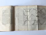 an open book with a drawing of a castle on it