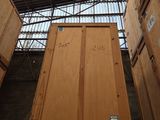 many wooden boxes stacked on top of each other in a warehouse